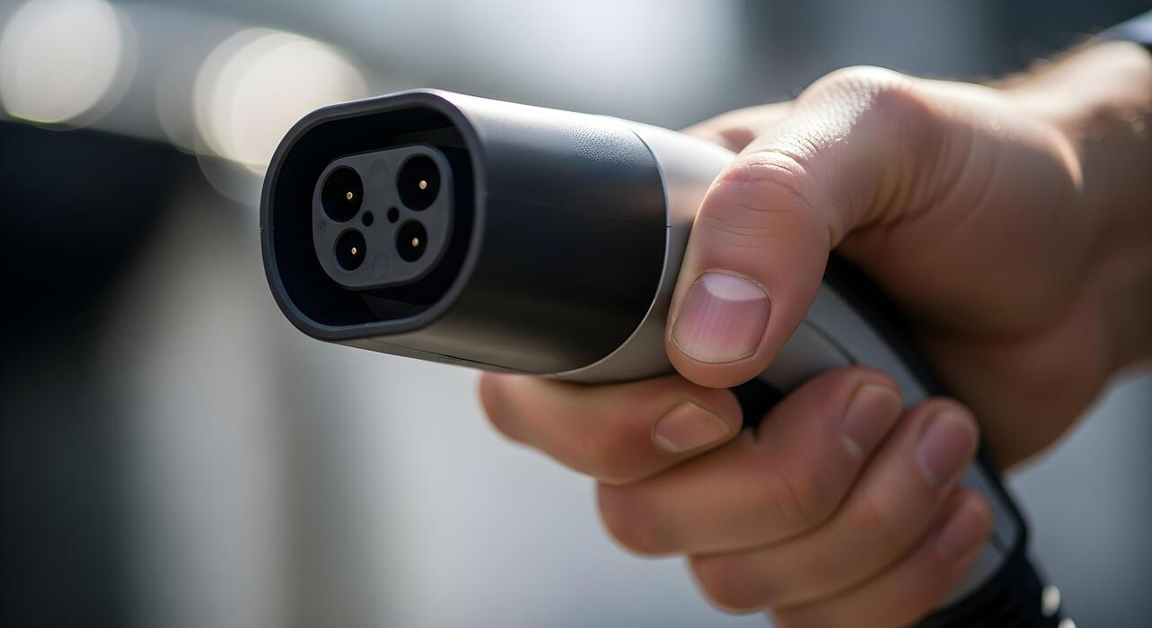 Close-up of EV charging plug being connected
